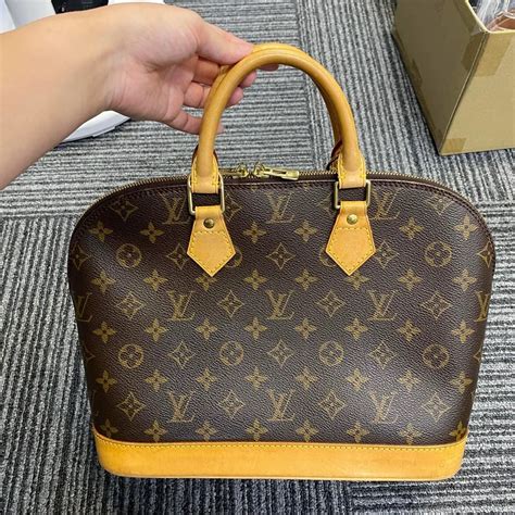 louis vuitton gold alma replica|real louis vuitton.